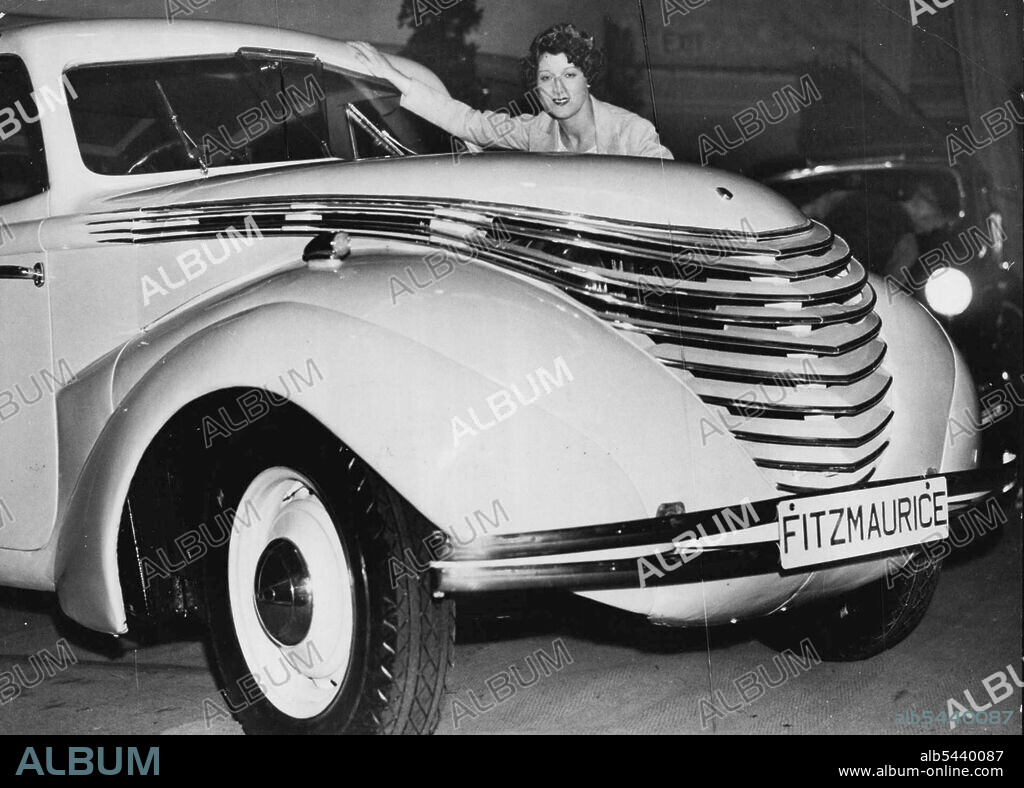 Opening of the great annual ford motor show, at The Royal Albert Hall, London. Miss Paddy Naismith, the well-known actress with a V8 Streamlines Saloon, Fitzmaurice body, priced at £495. October 15, 1936. (Photo by Sport & General Press Agency, Limited.).