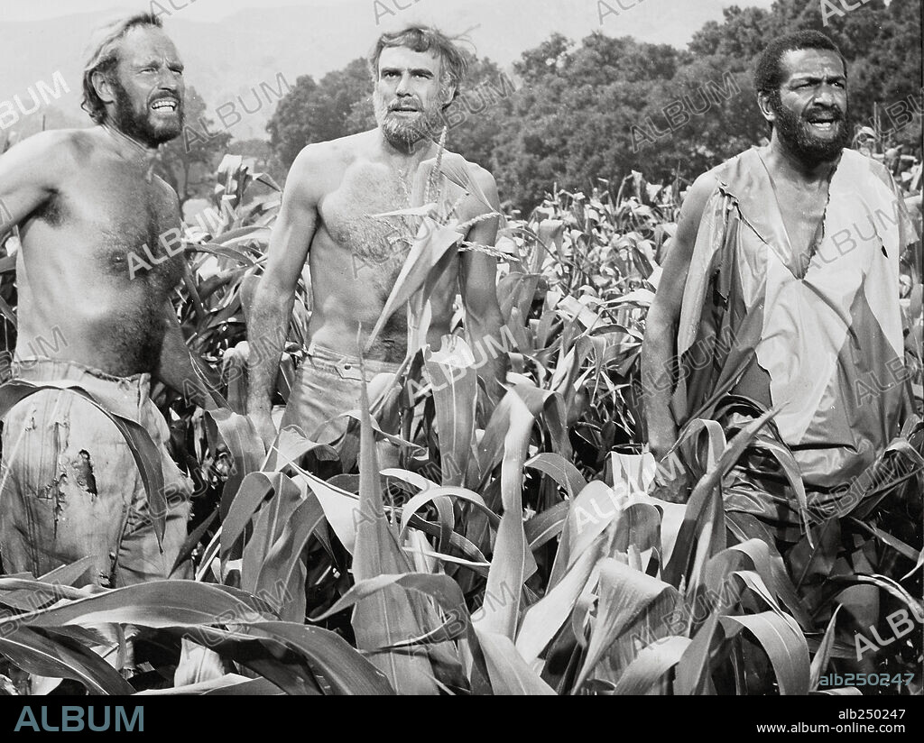 CHARLTON HESTON, JEFF BURTON and ROBERT GUNNER in PLANET OF THE APES, 1968, directed by FRANKLIN J. SCHAFFNER. Copyright 20TH CENTURY FOX.