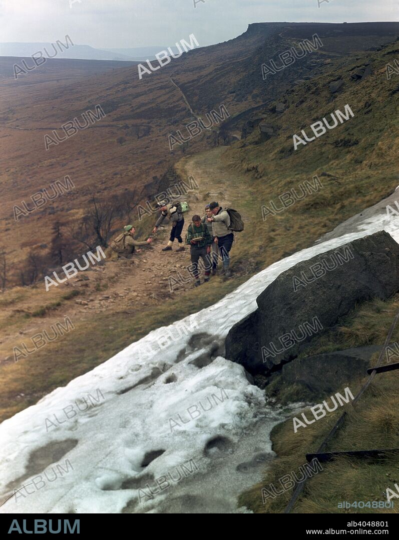Hikers on Stanage Edge, Hathersage, Derbyshire, 1964. Stanage is situated on the moors to the north of Hathersage, and is visible from the Hope Valley; it stretches for a length of about six kilometres (3.5 miles) from its northern tip at Stanage End to the southern point near the Cowper Stone. Halfway along, it is crossed by Long Causeway, the old Roman road from Navio (Brough) to Doncaster in South Yorkshire. It is a famous location for rock climbers and a popular spot for walkers.