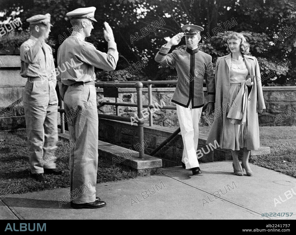 Donna Reed and Alan Ladd in Beyond Glory. American actress Donna Reed (Donnabelle Mullenger) walking beside American actor Alan Ladd saluting in the film Beyond Glory. 1948.