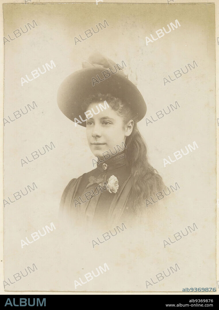 Portrait of a French girl with hat, brooch and flower, Part of Photo album of a French amateur photographer with shots of a family, distillery Delizy & Doistau Fils, the army and places of interest in France., anonymous, France, c. 1900 - c. 1910, paper, albumen print, height 142 mm × width 105 mm.