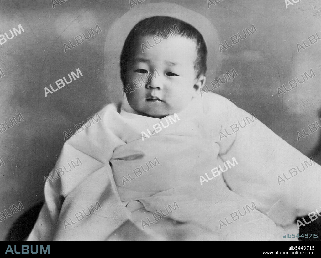 This excellent picture of H.R.H. Prince Akihito Tsugu-no-Miya, the Japanese Crown Prince, was taken today especially for press release for his coming first birthday to be celebrated in the Palace on December 23rd. According to the official announcement made simultaneously ***** release of the picture on his health is as follows ***** 705 gr. and 74cm. December 22, 1934. (Photo by The Shimbun Rengo News Photos Service).
