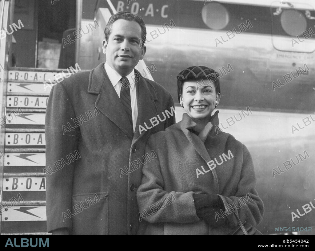 Margot And Her Husband Home -- Dr. Roberto Arias and his wife leaving the airplane. 
Britain's prima ballerina Margot Fonteyn and her husband Doctor Roberto Arias - newly appointed Panamanian Ambassador to Britain flew back to London yesterday from their Bahamas honeymoon. February 18, 1955. (Photo by Evening Standard Picture).