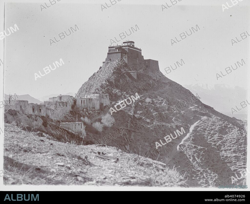 CHARLES ALFRED BELL. Iron Hill' [Chakpori], with Temple of Medicine on summit, Lhasa. View looking along the ridge towards the medical college. Photographs of Tibet and Sikkim. Bell collection. 438 prints 125x100mm to 160x115mm Gelatine silver prints, printing-out papers. Photographers: Sir Charles Bell, P. Brown, Johnston and Hoffmann, David Macdonald, Willoughby Patrick Rosemeyer, John Claude White. Source: Photo 1112/2(134).
