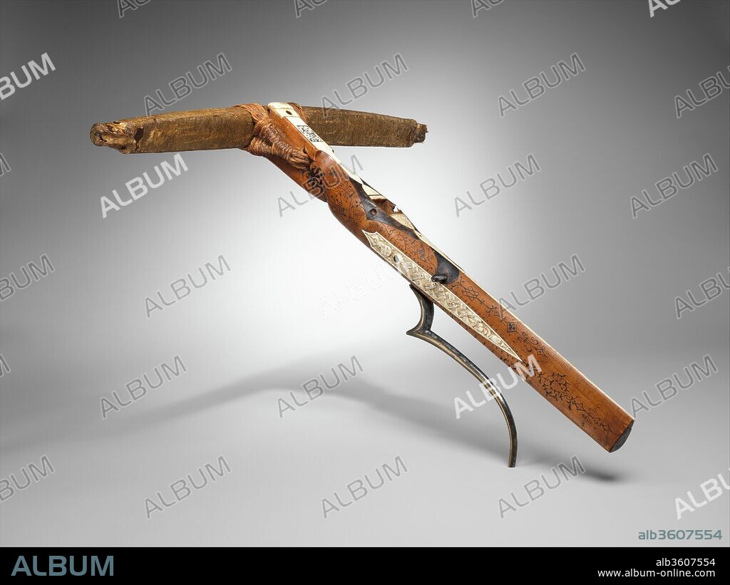 Crossbow of Count Ulrich V of Württemberg (1413-1480). Culture: German, probably Stuttgart. Dimensions: L. 28 1/16 in. (71.2 cm); W. 25 5/8 in. (65 cm); Wt. 6 lb. 9 oz. (2972 g). Maker: Attributed to Heinrich Heid von Winterthur (probably Swiss, active Stuttgart, recorded 1453-1460). Date: dated 1460.
Dated 1460 in the carved staghorn decoration, this is the earliest known dated crossbow in existence. The staghorn is inscribed with the coats of arms of Württemberg and Savoy, referring to the owner, Count Ulrich V of Württemberg (1413-1480), and his third wife, Princess Marguerite of Savoy (1420-1479). Above the trigger is a German benediction rendered in Hebrew letters. This is a rare and early instance of Hebraic script on a personal item intended for a Christian patron. It can be translated as "Hold God dear and be high-hearted!" or "Hold God dear, high-hearted one!".