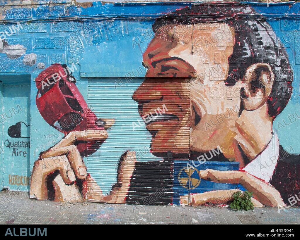 Pintura de cara de hombre de perfil con un coche pqueño en la mano cómo si fuese un cigarrillo sobre persiana y pared, graffiti mural, calle Marroc, barrio Poblenou; Distrito San Martin, Barcelona en 2016.
