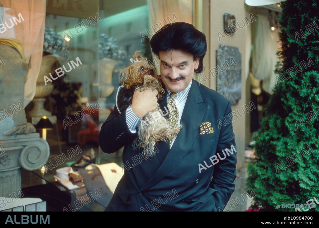 Fashion designer Rudolph Moshammer with Yorkshire terrier Daisy in front of his boutique at Munich, Germany 1996.