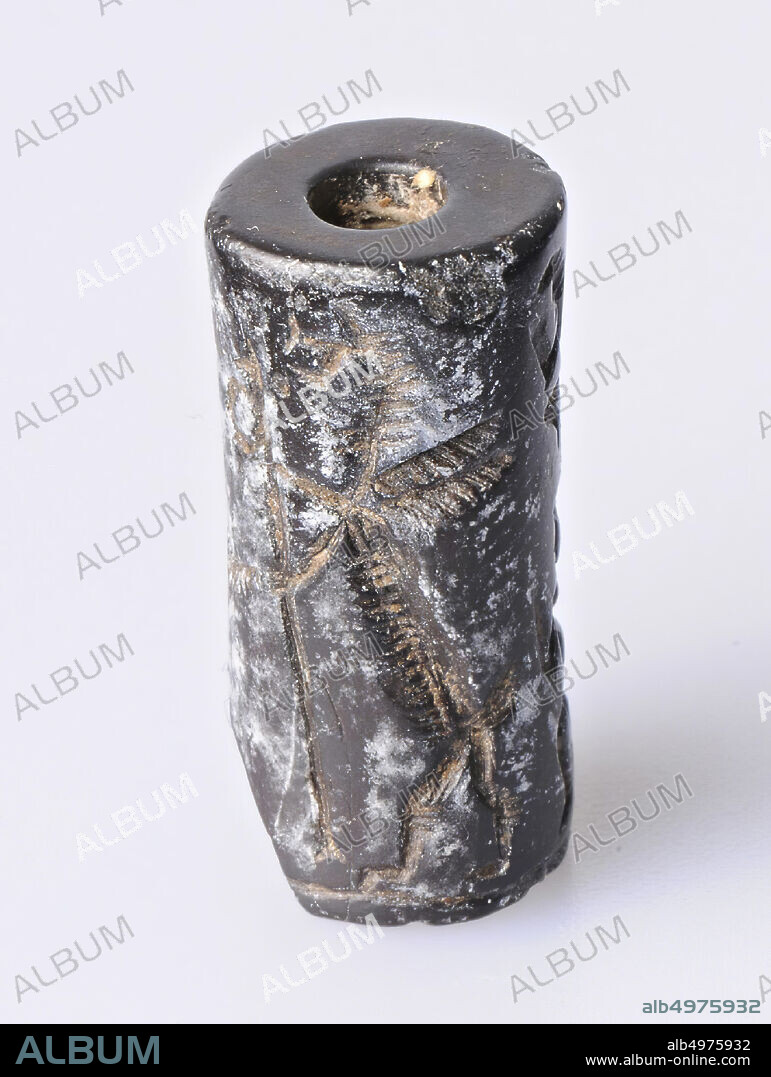 Vz: sun god with saw, winged dragon, bread and ring, double club, small frontal figure with head to the right and jackal, roll seal, hematite, Color: black, Form: cylinder, Processing:, Method:, L 21 mm, diam. 10 mm, 1st dynasty Babylon.