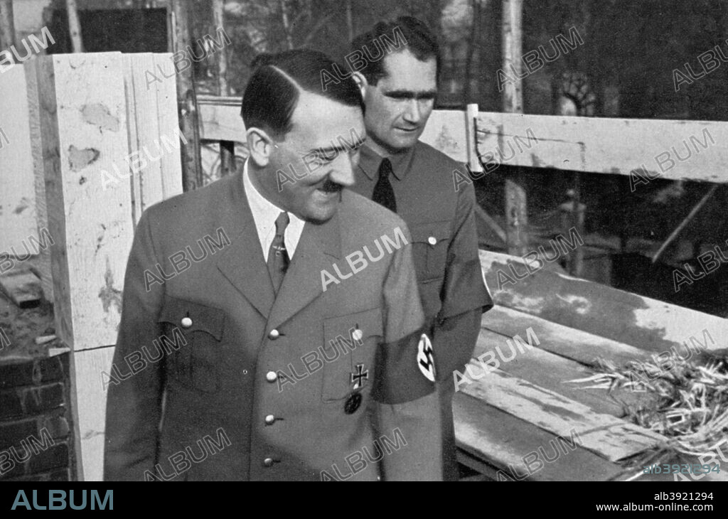 Adolf Hitler and Rudolf Hess visit the building of the Führer Buildings in Munich, Germany, 1936. German Nazi leader Hitler (1889-1945) and his deputy, Hess (1894-1987) checking on the progress of the construction. A print from Adolf Hitler. Bilder aus dem Leben des Führers, Hamburg: Cigaretten/Bilderdienst Hamburg/Bahrenfeld, 1936.