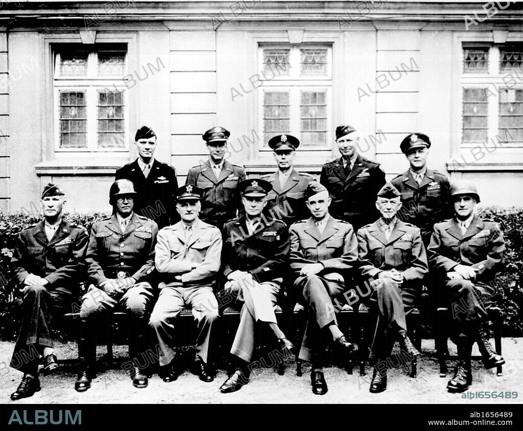 Senior American military officers during World War II. Seated (left to right) Generals William H. Simpson, George S. Patton, Carl A. Spaatz, Dwight D. Eisenhower, Omar Bradley, Courtney H. Hodges, and Leonard T. Gerow: standing (from left to right) Ralph.