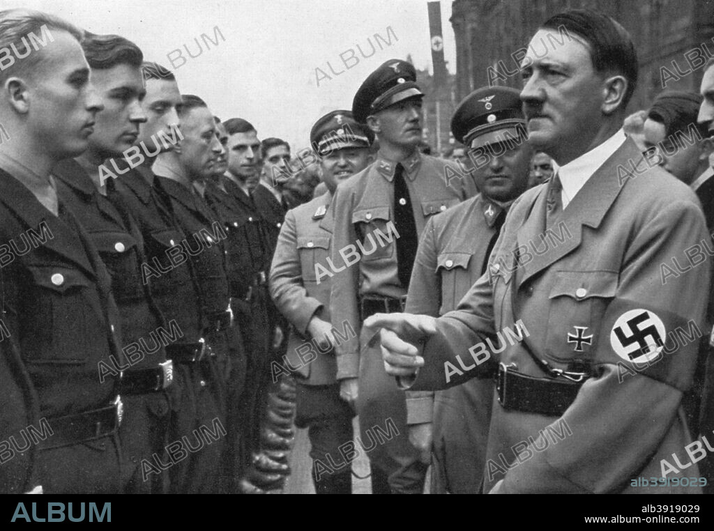 Adolf Hitler and Robert Ley, head of the German Labour Front, Nuremberg, Germany, 1935. Hitler (1889-1945) and Ley (1890-1945) at the Nuremberg Rally. A print from Adolf Hitler. Bilder aus dem Leben des Führers, Hamburg: Cigaretten/Bilderdienst Hamburg/Bahrenfeld, 1936.