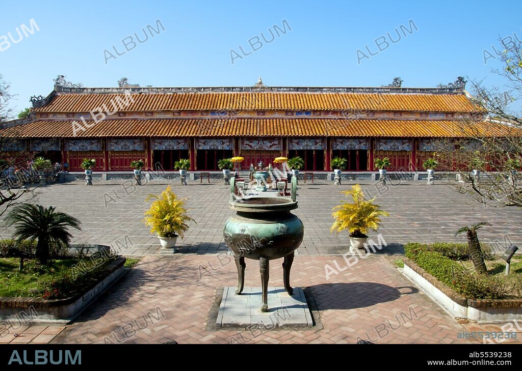 The Th? Mi?u, also called Th? T? Mi?u, is an ancestral temple and was constructed on the orders of Emperor Minh M?ng in 1822-1823. It honours the emperors of the Nguy?n Dynasty. Nine dynastic urns (Vietnamese c?u d?nh ??) in front of the Th? Mi?u were also cast in 1822 and dedicated to the first nine Nguyen emperors. Emperor Gia Long ordered the construction of Hue Citadel in 1805. The vast complex is built according to the notions of fengshui or Chinese geomancy, but following the military principles of the noted 18th century French military architect Sebastien de Vauban. The result is an unusual and elegant hybrid, a Chinese-style Imperial City carefully aligned with surrounding hills, islands and waterways, but defended by massive brick walls between 6-12 metres high and 2.5 metres thick, punctuated by towers, ramparts, a massive earth glacis, and 24 Vauban-inspired bastions. The entire complex was further protected by wide moats, crossed by gracefully arched stone bridges leading to ten gates, the chief of which is Cua Ngo Mon, the south-east facing ‘Meridian Gate’. To compound the exotic hybrid effect, guard posts designed as Chinese-style miradors, complete with sweeping eaves crowned by imperial dragons, surmounted each gate. Finally, directly in front of the Ngo Mon Gate, a massive brick fort 18 metres high was constructed both as an additional barrier against malign spirits, and as a defensive redoubt. The area within the Citadel - in all, 520 hectares (1300 acres) - comprises three concentric enclosures, the Civic, Imperial and Forbidden Purple Cities. Access is by way of ten fortified gates, each of which is reached by a low, arched stone bridge across the moat. In imperial times a cannon would sound at 5am and 9pm to mark the opening and closing of the gates. Hue was the imperial capital of the Nguyen Dynasty between 1802 and 1945. The tombs of several emperors lie in and around the city and along the Perfume River. Hue is a UNESCO World Heritage Site.