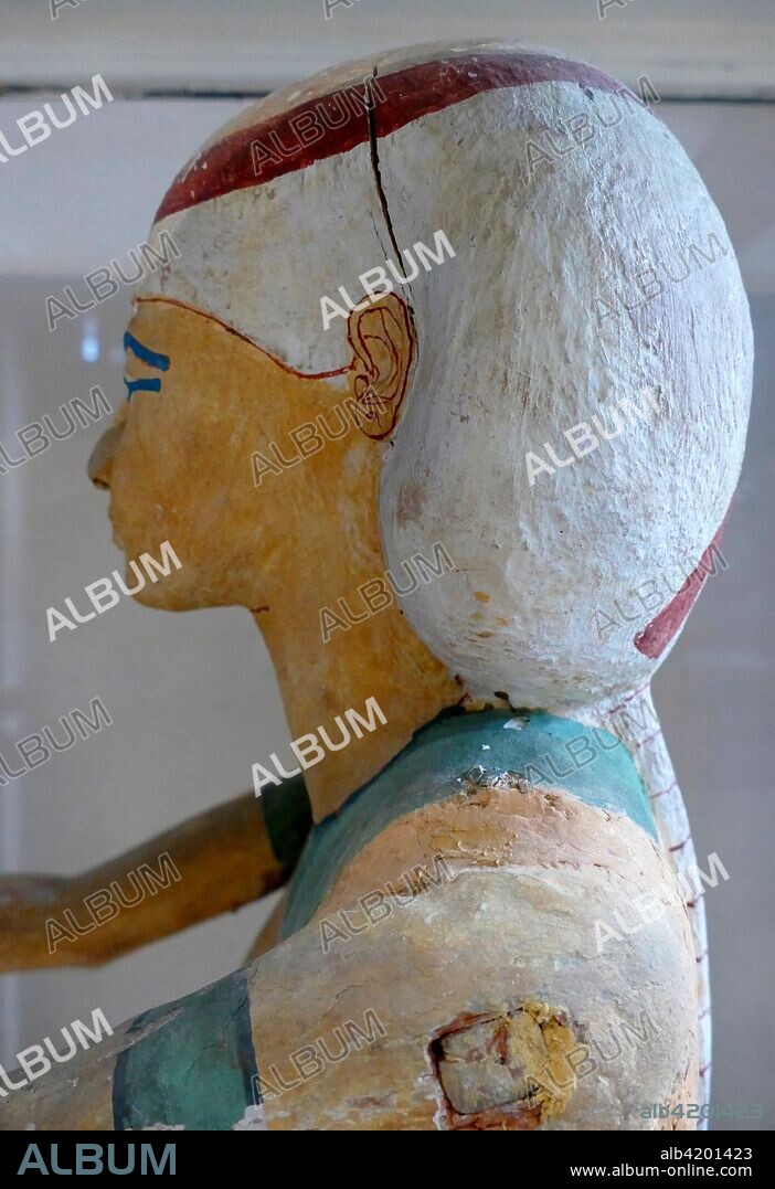 Statue of Nephtys. 21st Dynasty (c. 1070 - 946 BC). Cachette of the priests of Ajnun. Deir el-Bahari Statue of Isis wearing transparent dress tied with long belt. Her wig is circled and tied with band. She is sketching her arms to receive the deceased.