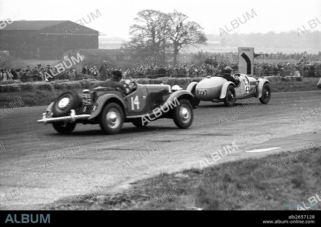 George Phillips driving MG TD II lead by No 26 Rodney F. Peacock driving the Frazer Nash Le Mans Replica 1 Hour sports car race International Trophy, Silverstone, England, 5th May 1951.