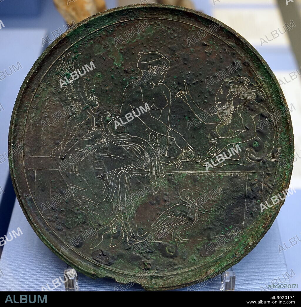 Bronze mirror-cover depicting Aphrodite and Pan playing knucklebones accompanied by Eros. Made in Corinth. Dated 350 BC.