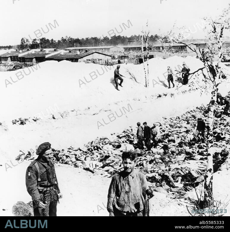 National Socialism: Concentration camps. Liberation of Bergen-Belsen by British troops of the 2nd Army on 15 April. 1945. The resident doctor Klein (in the foreground), who carried out experiments on prisoners, is made to assist in the burial of the dead. Photo, 1945.
