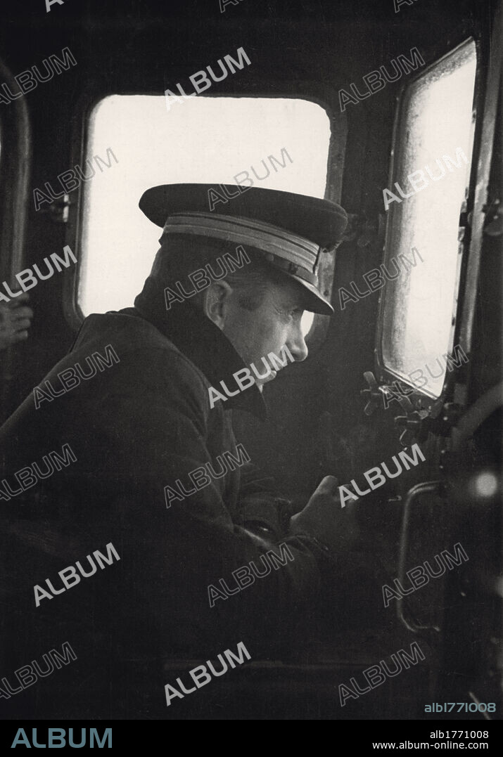 The Italian lieutenant commander Alberto Banfi. The Italian lieutenant commander Alberto Banfi on the hurricane deck of the torpedo-boat 'Airone'. He shall be decorated with a golden medal for military value for the victorious and heroic fight against an English torpedo-boat squadron on the 12th of October. In that occasion, he succeeded to hit the cruiser  'Ajax'; however, he was seriously injured and his boat wrecked. Mediterranean Sea, October 1940.