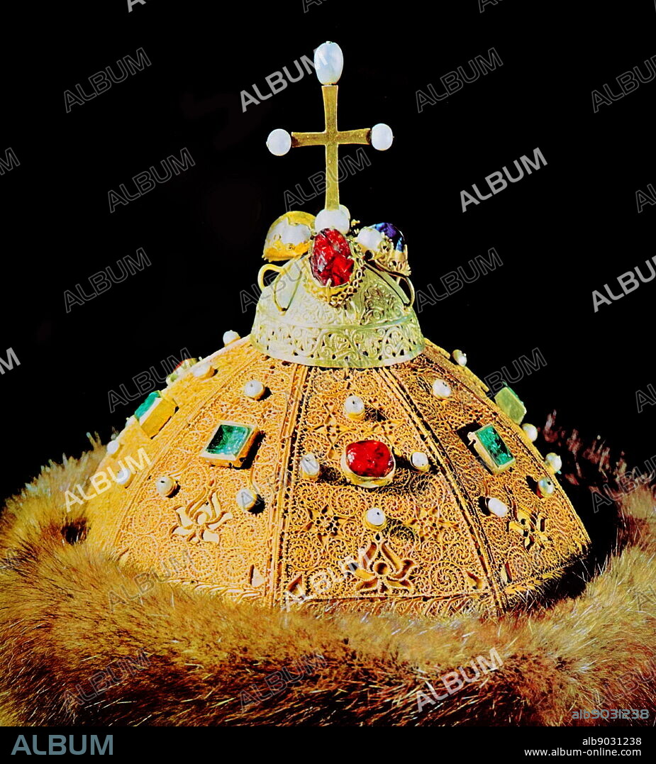 Monomakh's Cap (also called the Shapka Zolotaya), is relic of the Russian Grand Princes and Tsars. It is a symbol-crown of the Russian autocracy, and is the oldest of the crowns currently exhibited at the Kremlin Armoury. Monomakh's Cap is an early 14th-century gold filigree skullcap composed of eight sectors, elaborately ornamented with a scrolled gold overlay, inlaid with precious stones (ruby and emerald) and pearls, and trimmed with sable. Dated 14th Century.