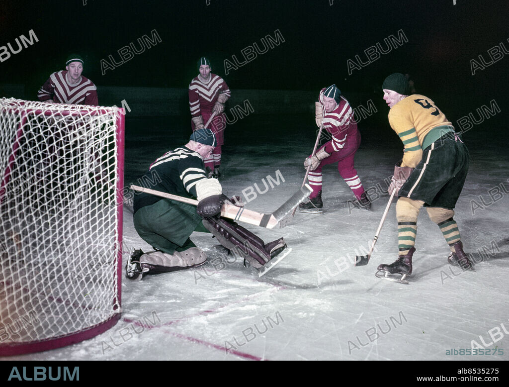 STOCKHOLM 1957-12-10. Sovjets målvakt Evgenij Erkin motar pucken med en benparad framför hans landsmän fr. v. Aleksej Gurysjev, Ivan Tregubov, Nikolaj Sologubov samt Tre kronors Ronald Sura-Pelle Pettersson i en ishockeylandskamp mellan Sverige och Sovjetunionen 10:e december 1957på Johanneshovs Isstadion i Stockholm. Sovjet vann matchen med 7-3.. Foto: Bertil Stilling / Expressen / TT / Kod: 40. **AFTONBLADET OUT**.