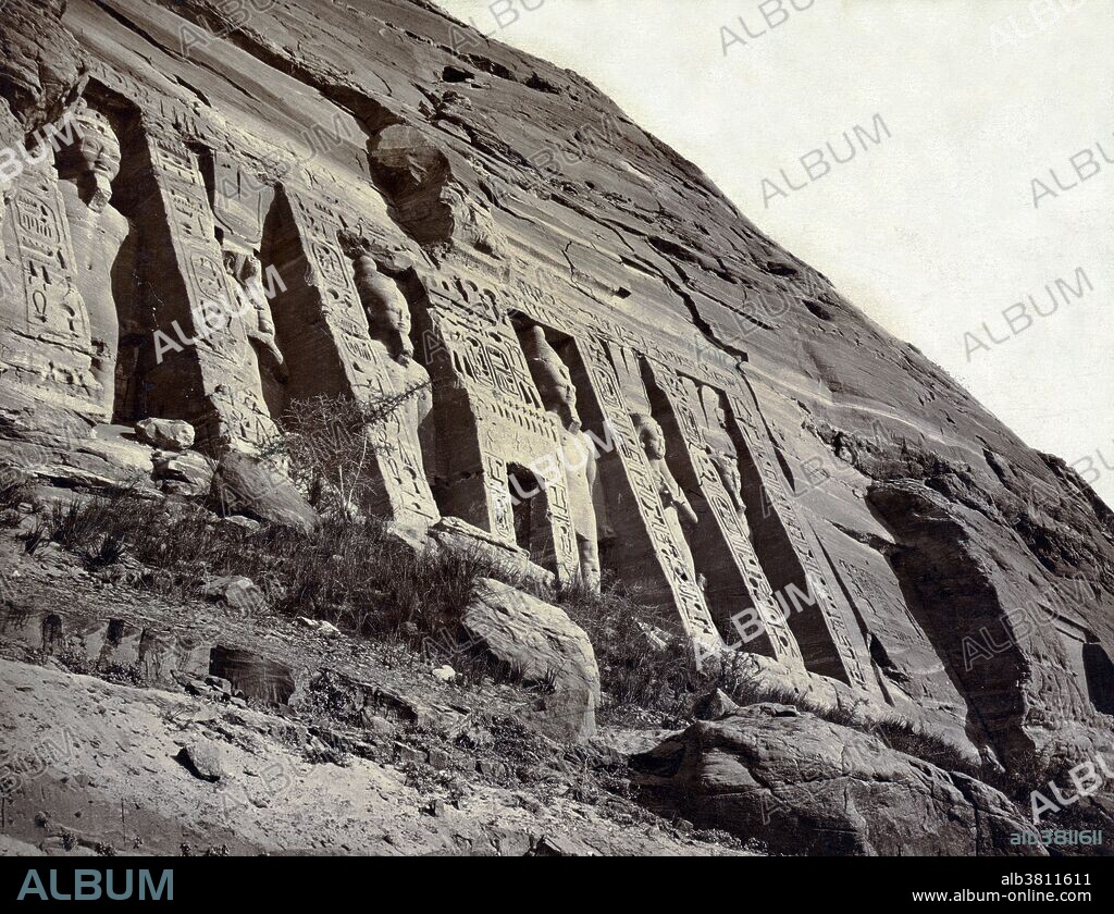 Entitled: "Nubie, Temple d'Abou Simbel dÃ©diÃ© Ã  Athor (Ã‰gypte)." View of facade of the small temple at Ab? Sunbul, Egypt, showing sculptures of Hathor and Ramses II. The Abu Simbel temples are two massive rock temples in Abu Simbel in Nubia, southern Egypt. The twin temples were originally carved out of the mountainside during the reign of Pharaoh Ramesses II in the 13th century BCE. Construction of the temple complex started in approximately 1264 BCE and lasted for about 20 years, until 1244 BCE. Known as the "Temple of Ramesses, beloved by Amun" it was one of six rock temples erected in Nubia during the long reign of Ramesses II. Their purpose was to impress Egypt's southern neighbors, and also to reinforce the status of Egyptian religion in the region. The complex was relocated in its entirety in 1968, on an artificial hill made from a domed structure, high above the Aswan High Dam reservoir. UNESCO World Heritage Site known as the Nubian Monuments. FÃ©lix Bonfils (March 8, 1831 - 1885) was a French photographer and writer who was active in the Middle East. He moved his family to Beirut in 1867 where they opened a photographic studio called "Maison Bonfils". Photographed by Maison Bonfils, circa 1867-1885.