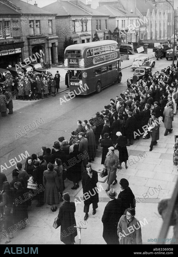 Crowds Gather As Christie Is Questioned -- Crowds line the street in lower Richmond Road today March 31st as John Reginald Christie was questioned in connection with the "Murder House" strangling of six women at Notting Hill. Christie, 55-year-old trucking clerk, for whom the Police of Britain have searched for seven days, was found by 43-year-old police constable Thomas Ledger. Putney Police Station, where Christie was being questioned when this picture was made, cannot be seen in picture, but small turning seen at left leads to it. April 16, 1953. (Photo by Associated Press Photo).