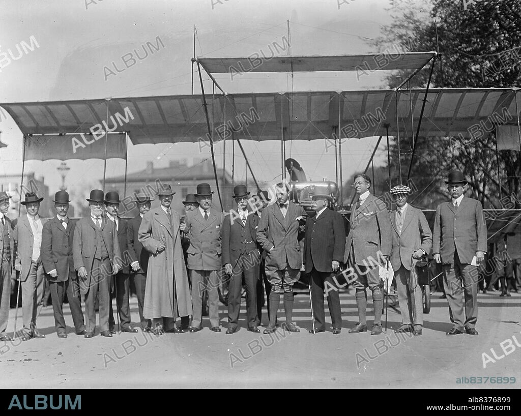 HARRIS & EWING. Grahame-White Flights, 1910. [Early aviation: British pioneer Claude Grahame-White (5th from right) flew his Farman biplane over Washington, D.C. and landed on West Executive Avenue near the White House].