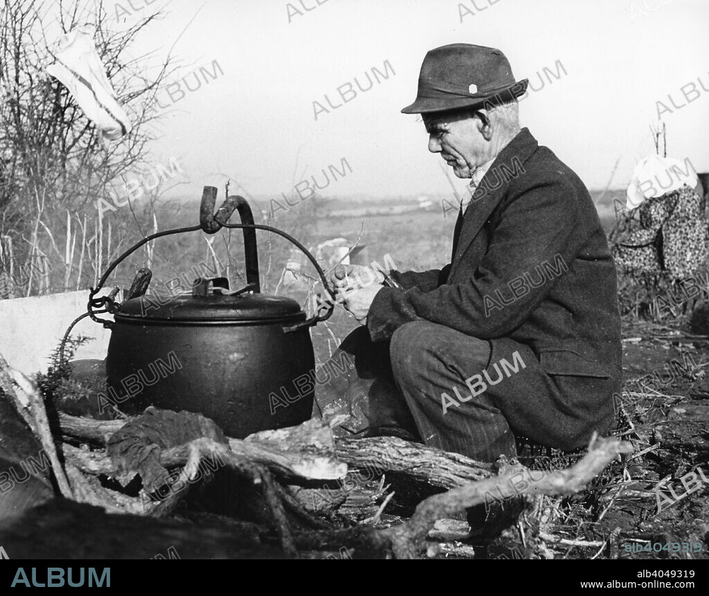 Gypsy man with cauldron, 1960s.