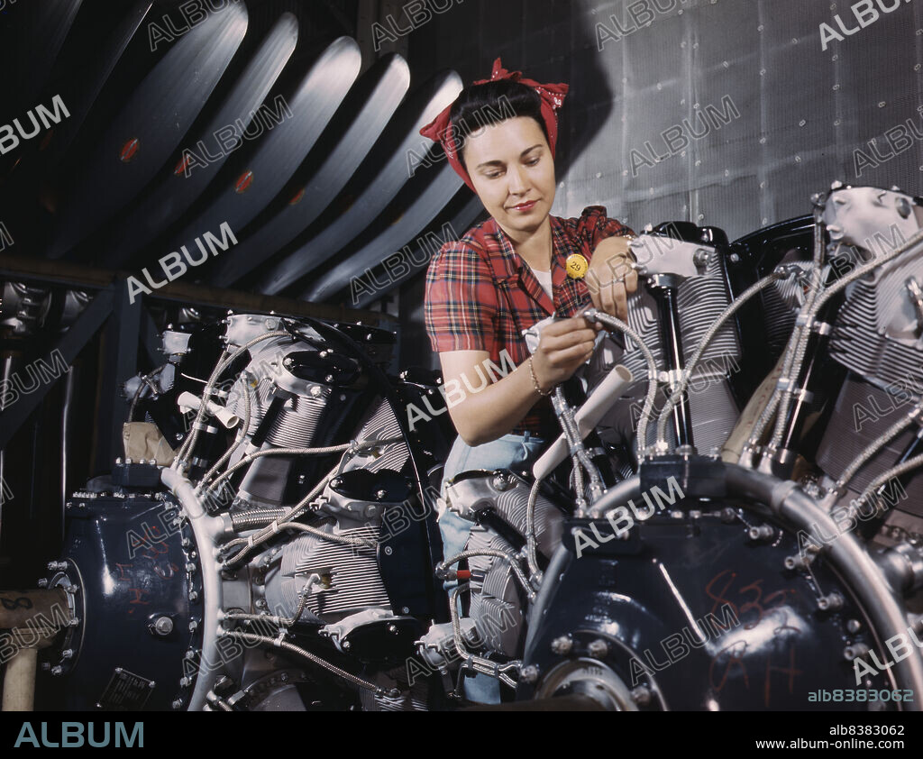 ALFRED T PALMER. Woman working on an airplane motor at North American Aviation, Inc., plant in Calif.