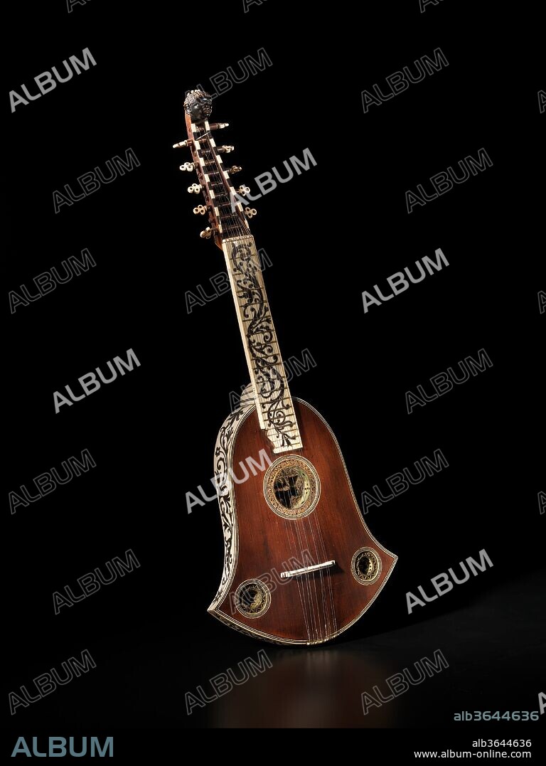 Cittern. Culture: German. Dimensions: Height: 24 7/8 in. (63.2 cm)
Width: 9 5/16 in. (23.6 cm). Maker: Joachim Tielke (German, 1641-1719). Date: ca. 1685.
The bell-shaped cittern was a specialty of the city of Hamburg and is properly referred to as the Hamburger Cithrinchen.  It was a fashionable instrument from about 1650 to 1750 from which time several examples survive.  This particular example is lavishly decorated with ebony foliate decoration on a white ground.  The cypress belly has three rosettes made of parchment and showing traces of an original green pigment.  The pegbox has the head of a Moorish king.  
Citterns are plucked stringed instruments, related to lutes and guitars, but strung with metal strings which produce a brighter and louder sound than gut strings.  The cittern also has inlaid metal frets, as opposed to tied gut frets on lutes and early guitars.  Players of the cittern use a plectrum to pluck the five or six courses of strings.  Primarily a folk instrument that continues to be used in traditional musical styles, the cittern was elevated to the position of an art instrument by aristocrats in the sixteenth and seventeenth century, one of whom probably originally owned this extravagant instrument.