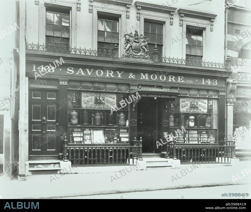 Savory & Moore's Pharmacy, 143 New Bond Street, London, 1912. Shop front with window display and royal coat of arms over the door indicating 'by appointment' to the royal family. Savory & Moore was established here by Thomas Field Savory in 1797. The shop continued to function until 1968 when it was closed and the fittings and contents were presented to the Wellcome Institute of the History of Medicine. In 1971 the pharmacy was transported to Melbourne, Australia, and reconstructed in the Medical History Museum to reflect the essential features of a mid-Victorian pharmacy and also to serve as the backdrop for exhibiting various forms of glass and other containers used in such a pharmacy.