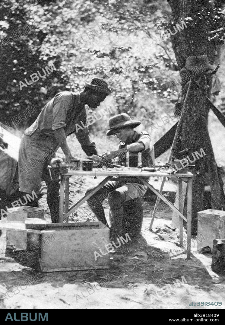 Errol Hinds and Julius Mapata, Livingstone to Broken Hill, Northern Rhodesia, 1925 (1927). A print from Cape to Cairo, by Stella Court Treatt, George G Harrap & Company Ltd, 1927. The book was an account of the first successful journey by motor vehicle from Cape Town to Cairo, accomplished by Stella Court Treatt and her husband, Major Chaplin Court Treatt, in 1924-1926. Errol Hinds (1908-1980), Stella's younger brother, and Julius Mapata were also members of the expedition. Mapata, a Malawi chief, had been Chaplin's servant in South Africa since 1916. He spoke 32 native dialects as well as English.