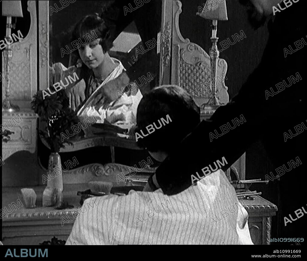 Female Civilian Having Her Hair Cut Into a 'Shingle' by a Male Civilian Hairdresser, 1920s. From "Time to Remember - Teenage Flapper", 1920s (Reel 4); a dcumentary about women's lives in the 1920s - great commentary by Joyce Grenfell.