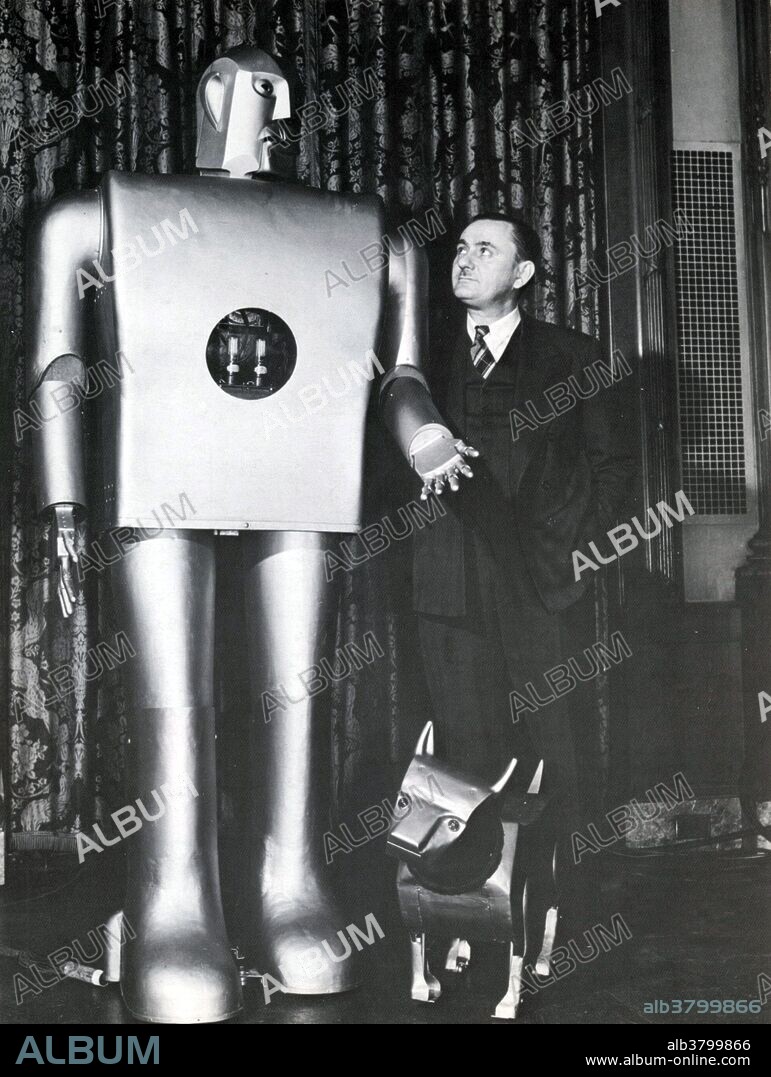 Electro the motor man and Sparko with creator J.M. Barrett New York Worlds Fair 1939. These animatronic wonders marked the first time that electric motors were used to power and actuate robots. The term "robot" was first used to denote fictional automata in a 1921 play R.U.R. by the Czech writer, Karel Capek.  In 1928, one of the first humanoid robots was exhibited at the annual exhibition of the Model Engineers Society in London. Invented by W. H. Richards, the robot Eric's frame consisted of an aluminum body of armor with eleven electromagnets and one motor powered by a twelve-volt power source. The robot could move its hands and head and could be controlled through remote control or voice control. Westinghouse Electric Corporation built Televox in 1926; it was a cardboard cutout connected to various devices which users could turn on and off. In 1939, the humanoid robot known as Elektro was debuted at the 1939 New York World's Fair. Seven feet tall and weighing 265 pounds, it could walk by voice command, speak about 700 words (using a 78 rpm record player), smoke cigarettes, blow up balloons, and move its head and arms. The body consisted of a steel gear, cam and motor skeleton covered by an aluminum skin. The branch of technology that deals with the design, construction, operation, and application of robots is robotics.