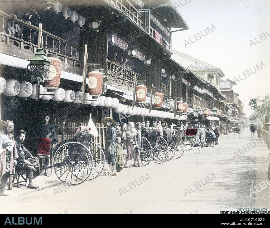 [ 1880s Japan - Matsushima Brothels, Osaka ] Rickshaws parked in front of brothels in the Matsushima Yukaku (prostitution district) of Osaka. Matsushima was created in 1868 (Meiji 1), nearby Osakas foreign settlement of Kawaguchi. The brothel district was established the following year. In 1945, the area was completely destroyed by US fire-bombings. 19th century vintage albumen photograph.