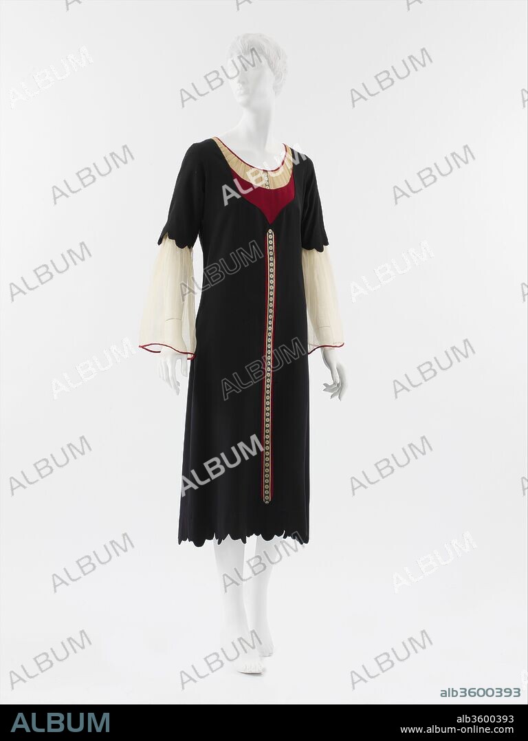 Dress. Culture: French. Designer: Paul Poiret (French, Paris 1879-1944 Paris). Date: 1925.
Because of their bold coloring, rich detailing, dramatic (if simple) silhouettes, and immediately recognizable references, designs by Poiret in the orientalist mode came to represent the strongest identity of his house. In fact, Poiret's collections were an amalgamation of all his interests. Rather than one unified theme, his presentations offered clients a range of silhouettes and stylistic effects. Many designs cited menswear, sportswear (something Poiret would eventually repudiate as an inappropriate style for the haute couture), and historical styles, especially those from antiquity, the Middle Ages, the Renaissance, and the Second Empire, in a heady eclectic mix. 
Although 'Bouclier' appears to preclude another period or culture that might have been its inspiration, Poiret's informed historicism reveals itself in the trompe l'oeil detail of narrow placket printed with a button motif, which references the button-down pinafore dresses of the 1880s. The effect is of an illusion of a sheer cotton blouse or chemise under a red dress with a navy overdress. While its design features are primarily frontal, Poiret added a decorative bow to the back neckline, reinforcing its playful spirit.
Through its color palette and its association with the chic style of young Parisiennes, the dress alludes to French national identity. It was represented in Art-Goût-Beauté with another model called 'École,' also rendered in blue, white, and red. Both dresses were paired with matching accessories to underscore their nationalistic overtones. Poiret was a fierce patriot despite having been criticized during World War I for his boche taste because of a cartoon in the German comic paper Simplicissimus that featured a German housewife being assured by her soldier husband that she would soon get a new Poiret dress. Indeed, for Poiret, orientalism and classicism, often seen as rival aesthetic models in the discourse of modernism, were mutually reinforcing expressions of his patriotism, so deep-rooted were they in the cultural politics of France.