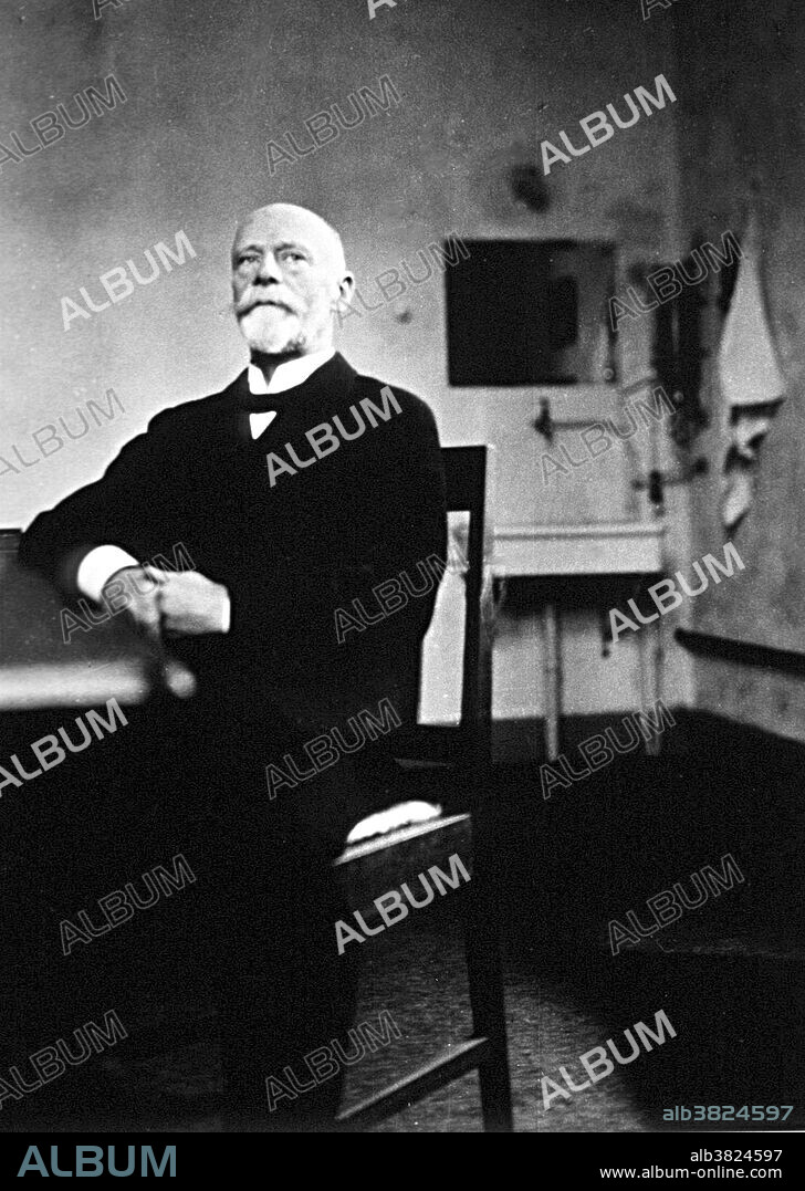 Einthoven seated at table in laboratory. Willem Einthoven (1860-1927) was a Dutch doctor and physiologist. He invented the first practical electrocardiogram (ECG or EKG) in 1903 and received the Nobel Prize in Medicine in 1924 for it. In 1901, Einthoven completed a series of prototypes of a string galvanometer. This device used a very thin filament of conductive wire passing between very strong electromagnets. When a current passed through the filament, the electromagnetic field would cause the string to move. A light shining on the string would cast a shadow on a moving roll of photographic paper, forming a continuous curve showing the movement of the string. His assignment of the letters P, Q, R, S and T to the various deflections is still used. The term "Einthoven's triangle" is named for him. It refers to the imaginary inverted equilateral triangle centered on the chest and the points being the standard leads on the arms and leg. After his development of the string galvanometer, Einthoven went on to describe the electrocardiographic features of a number of cardiovascular disorders.