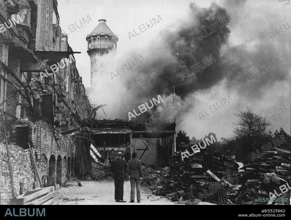Another Fire Breaks Out In Crystal Palace Ruins - Firemen at work on the blazing art school building. The roof fell in and the building was gutted.Another fire broke out in the ruins of the Crystal Palace the famous glass exhibition hall on Sydenham Hill. Here which was destroyed in the fire of the century last winter. This afternoon today the former art school building and skating rink, saved from the flames before, was burnt out. August 19, 1937. (Photo by Associated Press Photo).