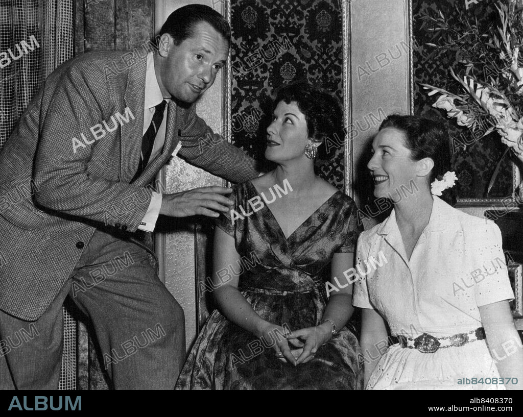 Charles ("Bud") Tingwell (left) and Anne Bullen (right) congratulate Margaret Christensen on her Macquarie award win at a party given in Margaret's honor this week by her associates in the Colgate radio shows, on which all three are commercial announcers. Margaret will be heard in the Macquarie Award presentation play, Green Waters, next Sunday night. March 12, 1954. (Photo by Polkinghorne And Stevens).