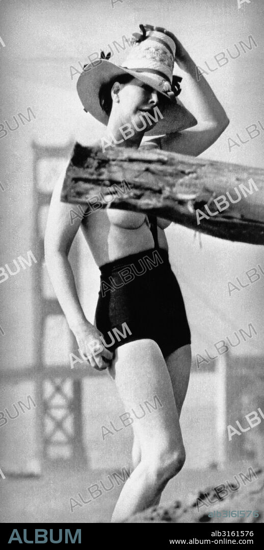 San Francisco, California: June 16, 1964 A young woman models Rudy Gernreich's topless bathing suit, the 'monokini', with the Golden Gate Bridge as a backdrop.
