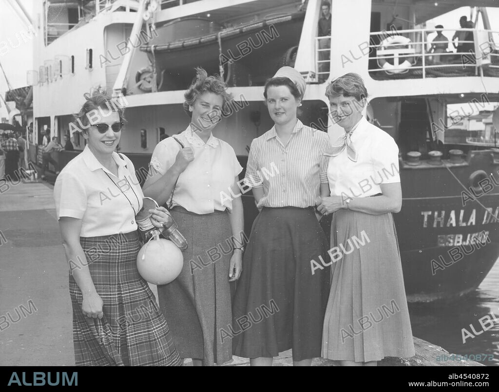 Photograph - Isobel Bennett, Susan Ingham, Mary Gillham & Hope Macpherson Before Boarding Thala Dan, Appleton Dock, West Melbourne, Dec 1959, Black and white image of Hope Macpherson who along with Isobel Bennett, Susan Ingham and Mary Gillham were the first women to visit the Antarctic, travelling on board the Thala Dan for their expedition in December 1959. Hope Macpherson was the first female curator at National Museum of Victoria (now Museum Victoria). Left to right: Hope Macpherson, Mary Gillham, Susan Ingham and Isobel Bennett.