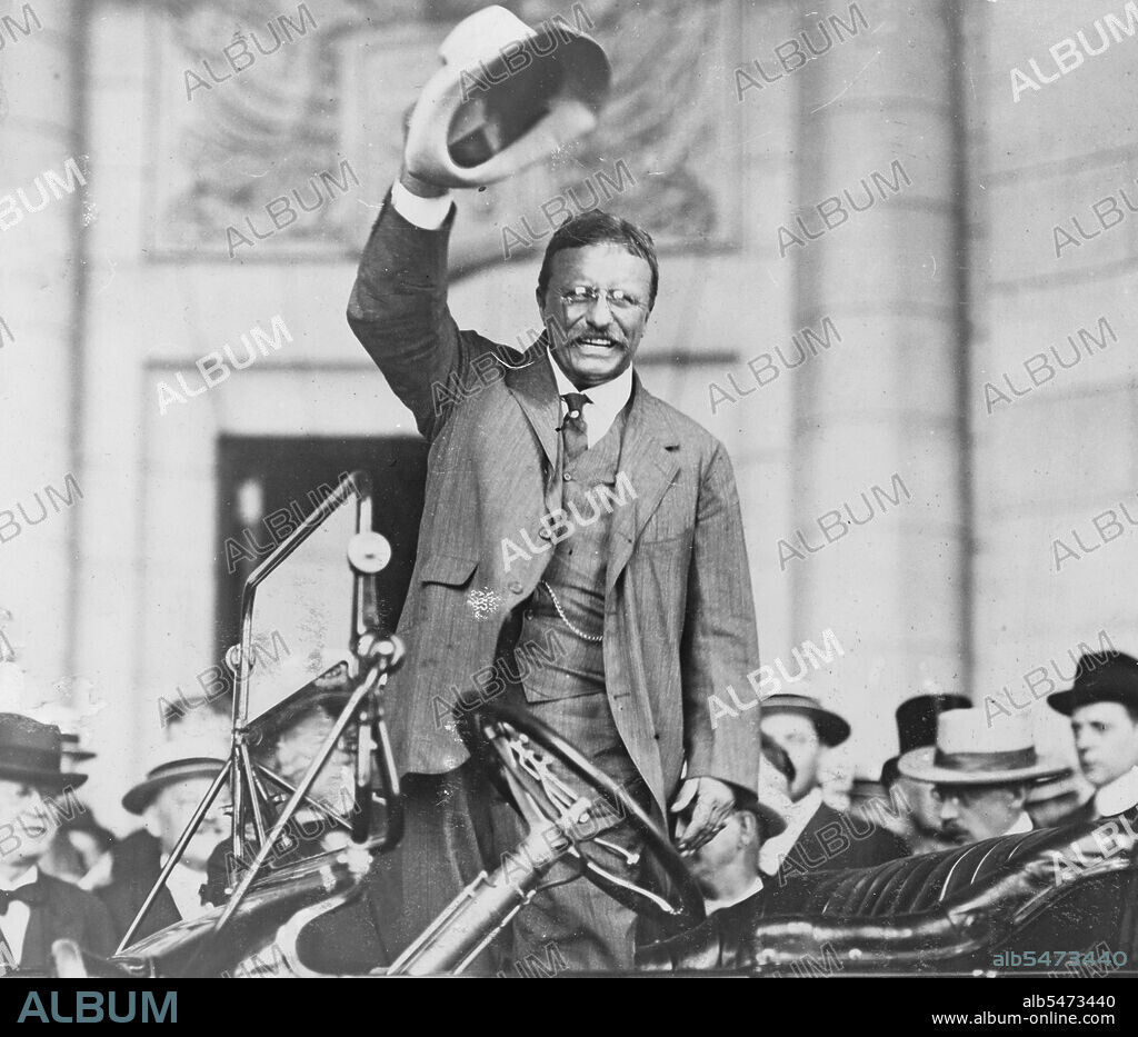 Theodore Roosevelt, three-quarter length portrait, standing up in car, waving hat ca. between 1909 and 1932.