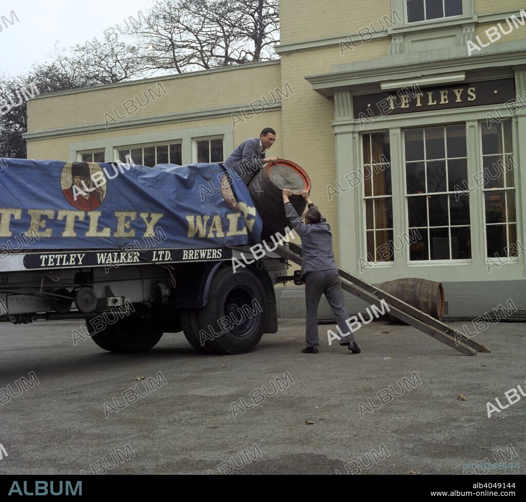 Draymen from Tetley & Walker, Leeds, West Yorkshire, 1969. Draymen unloading beer barrels during a delivery to a pub.