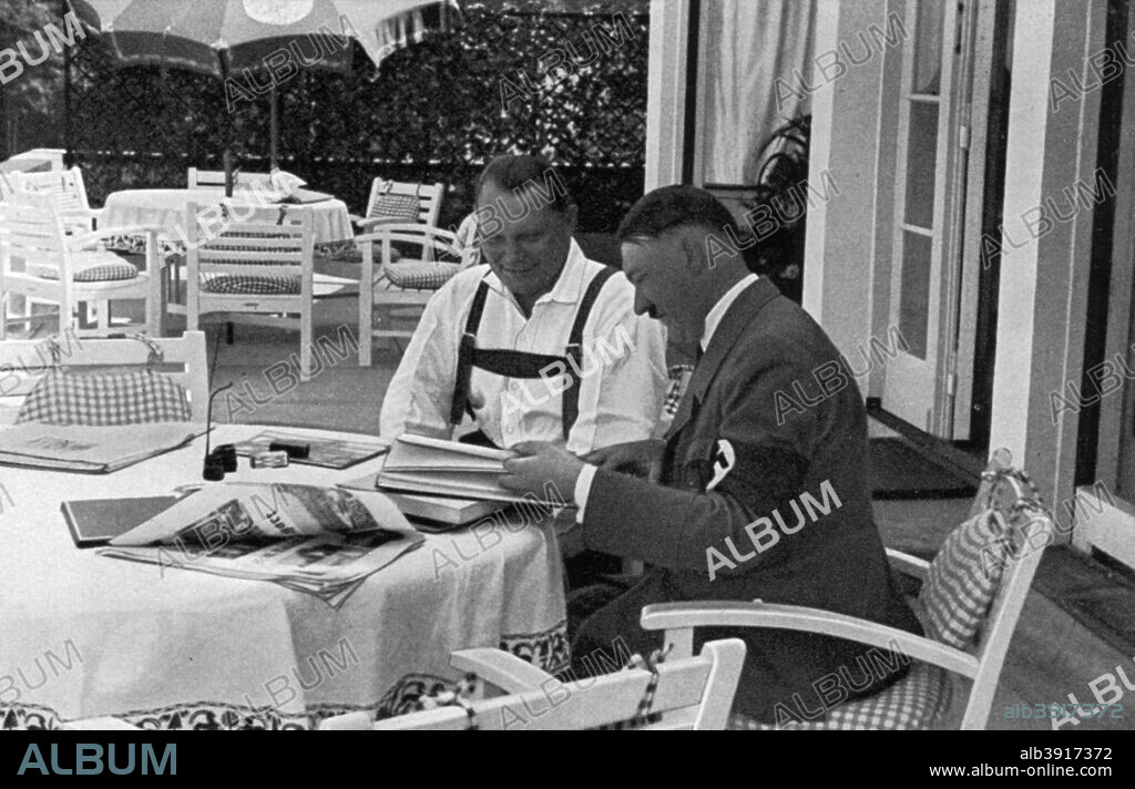 Hermann Goering and Adolf Hitler at his residence in Obersalzberg, Bavaria, Germany, 1936. Goering (1893-1946) and Nazi leader Hitler relaxing at Hitler's mountain retreat, the Berghof. A print from Adolf Hitler. Bilder aus dem Leben des Führers, Hamburg: Cigaretten/Bilderdienst Hamburg/Bahrenfeld, 1936.