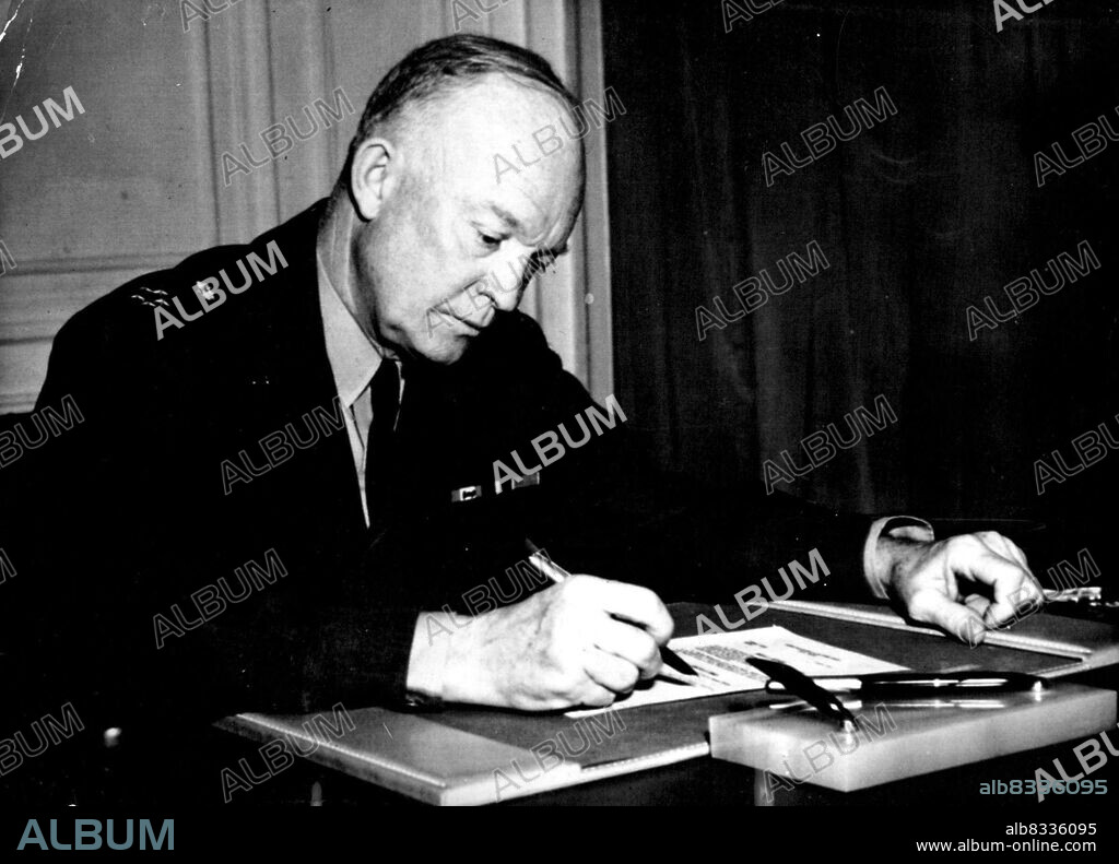 The Umbrella Man - General Dwight D. Eisenhower signs the order making shape operational, at the shape he headquarters in Paris today, April 2. Addressing a press conference afterwards General Eisenhower said "I am here just to help provide an umbrella over it (the North Atlantic treaty countries) all." The press conference was the first he has given since taking over command formally at one minute past midnight today.Eisenhower said that taking over command was simply a formal in keeping with the old military tradition that a new commander should issue a number one order announcing that he had taken command. April 17, 1951. (Photo by Associated Press Photo).