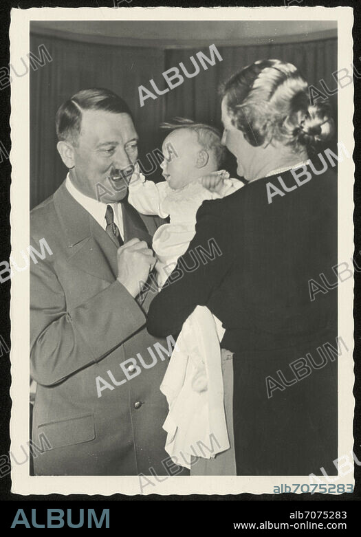 Hitler, Adolf Dictator (NSDAP). 1889-1945. - Hitler at Edda Goering's christening, 1938: Hitler, Edda and her mother Emmy Goering (maiden name: Sonnemann), a former actress. Photo, 1938.