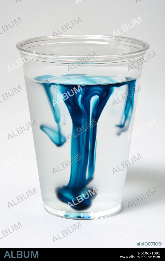 Demonstration of convection currents in a cup of ice water. Water, in its solid state of ice, floats. As the ice melts, the warmer water sinks, as shown by the added blue food dye.