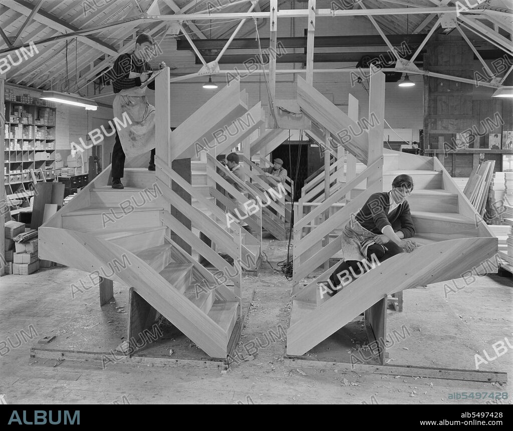 JOHN LAING PLC. Victoria Joinery Works, Magdalen Street, Earlsfield, Wandsworth, London, 25/11/1966. The interior of Victoria Joinery Works, showing a team of men at work on the manufacture of wooden staircases for 12M Jespersen dwellings. Victoria Joinery Ltd was originally part of the Holloway Brothers group, acquired by John Laing & Son Ltd in 1964. The works was on Magdalen Street in Earlsfield but has since been demolished and housing now occupies the site. The photograph is part of a batch showing staircases manufactured at the works, later to be installed in Laing's 12M Jespersen homes.