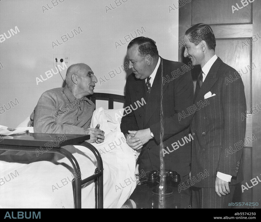 Trygve Lie Visits Dr. Mossadegh -- United Nations Secretary-General Trygve Lie (center) pays a visit in New York Hospital to Dr. Mohammed Mosssadegh, Prime Minister of Iran. At right, Ambassador Nasrollah Entezam, of Iran, President of the fifth session of the General Assembly. Dr. Mossadegh is presently in New York to attend the Security Council meetings on the Iranian oil dispute. October 12, 1951. (Photo by UNations).