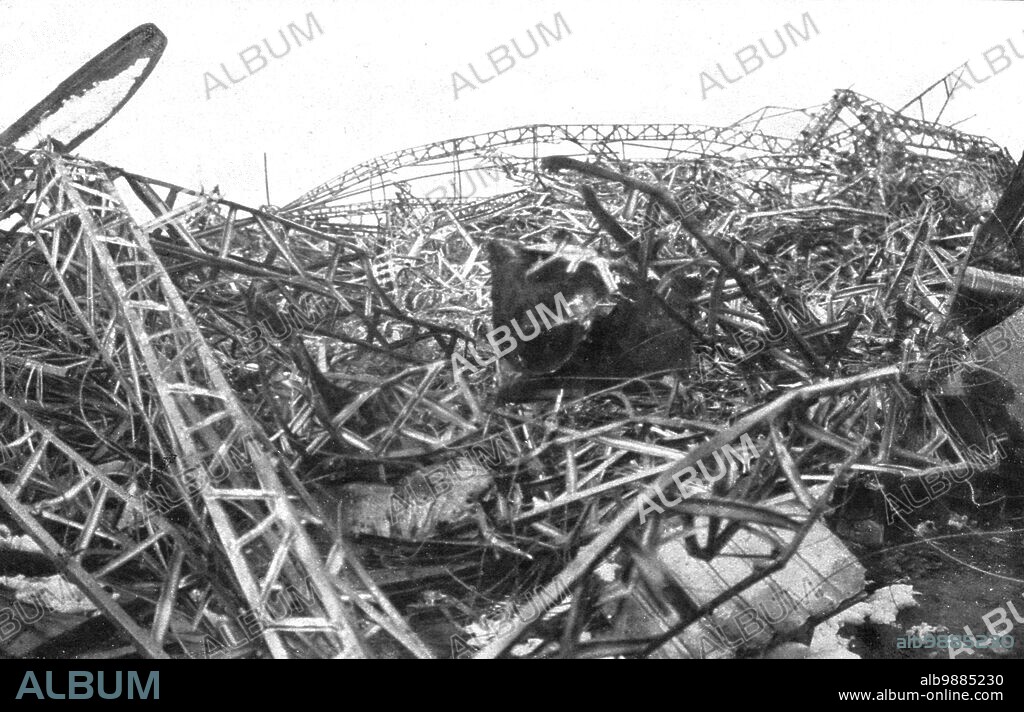 'Un Zeppelin abattu a Revigny; Les restes de la carcasse du dirigeable allemand L. Z.-77, abattu le 21 fevrier 1916 a Revigny, dans la Marne, par une sectionfrancaise d'autos-canons: au milieu des decombres, le cadavre nu d'un soldat de l'equipage qui comptait 28 hommes et perit tout entier', 1916. From "L'Album de la Guerre 1914-1919, Volume 1" [L'Illustration, Paris, 1924].