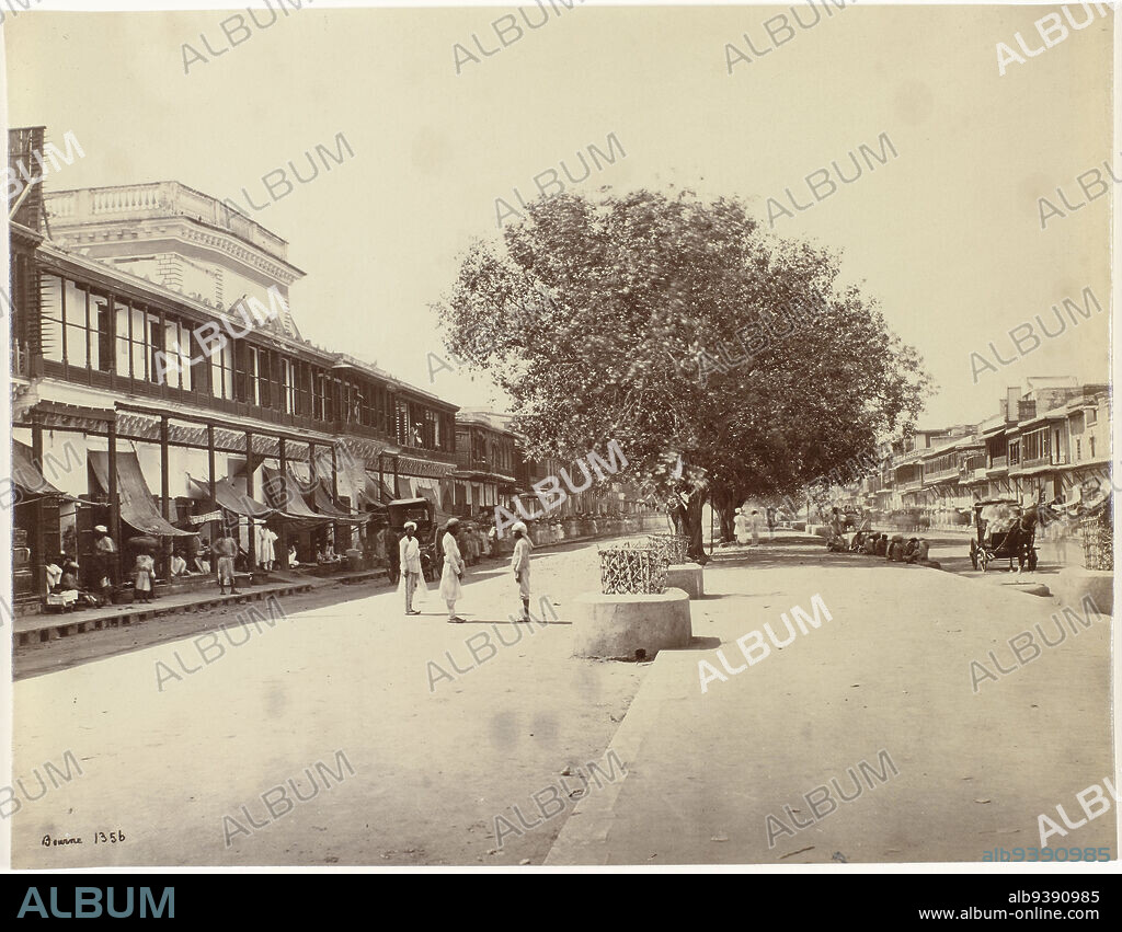 View of Chandni Chowk in Shahjahanabad, Delhi, India, The Chandni-chouk, principal Street in Delhi (original title), Chandni Chowk is the main street of Shahjahanabad, the last of the seven historic cities of Delhi. Along the road are stores and artisans selling their wares. The street was laid out in 1650 by Jahanara Begum, the daughter of Emperor Shah Jahan, and connected the city to their fortified palace, The Red Fort. The street was 36 meters wide (40 yards) and 1.3 kilometers long (1520 yards). Originally, there was a canal along the road to supply the fort with drinking water and irrigation. Between 1840 and the 1860s the canal was filled in by the British. The shot shows a raised ledge where the canal once ran., Samuel Bourne (signed by artist), Old Delhi, 1865 - 1870, paper, albumen print, height 220 mm × width 286 mm.